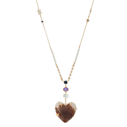 From the whimsical Fairydusted Collection, the Titania Heart Necklace embodies a playful elegance and a curated sense of charm. Featuring a heart-shaped agate at its center, the necklace is adorned with a magical scattering of moonstones (.62 cts), opals (17 cts), iolite (.23 cts), sapphires, pearls, and a sparkling diamond (.11 cts). Set on an adjustable 18k gold chain, it can be worn at lengths from 17" to 21".