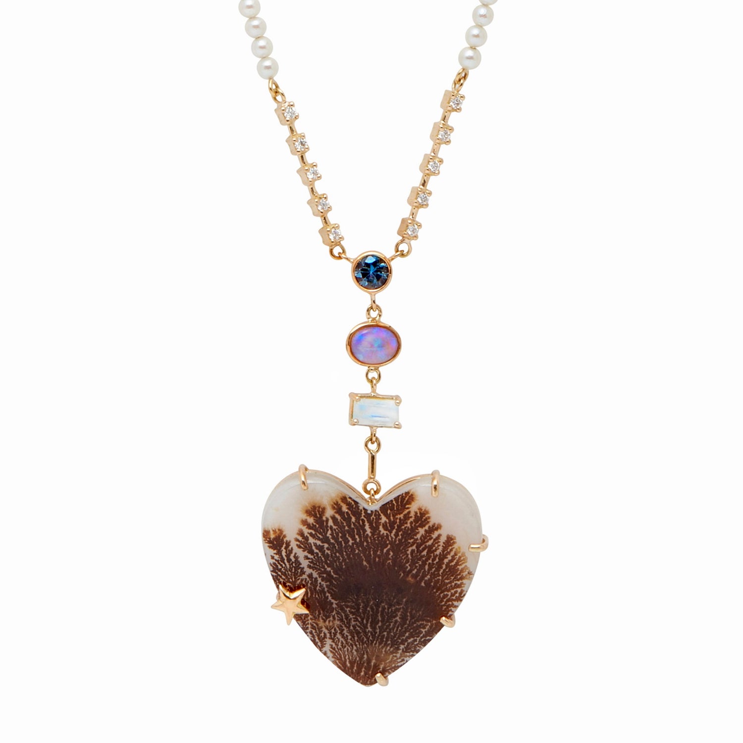 From the whimsical Fairydusted Collection, the Titania Heart Necklace embodies a playful elegance and a curated sense of charm. Featuring a heart-shaped agate at its center, the necklace is adorned with a magical scattering of moonstones (.62 cts), opals (17 cts), iolite (.23 cts), sapphires, pearls, and a sparkling diamond (.11 cts). Set on an adjustable 18k gold chain, it can be worn at lengths from 17" to 21".