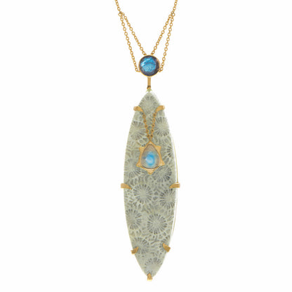 Ba Li Dynasty Necklace by Unhada - A harmonious blend of nature and history, this necklace showcases a marquise-cut fossilized coral centerpiece, framed by faceted labradorite and a luminous moonstone. Crafted in 18k gold, the pendant’s details evoke ancient elegance. Pendant measures 2.3" x 0.6" on a 26" chain.